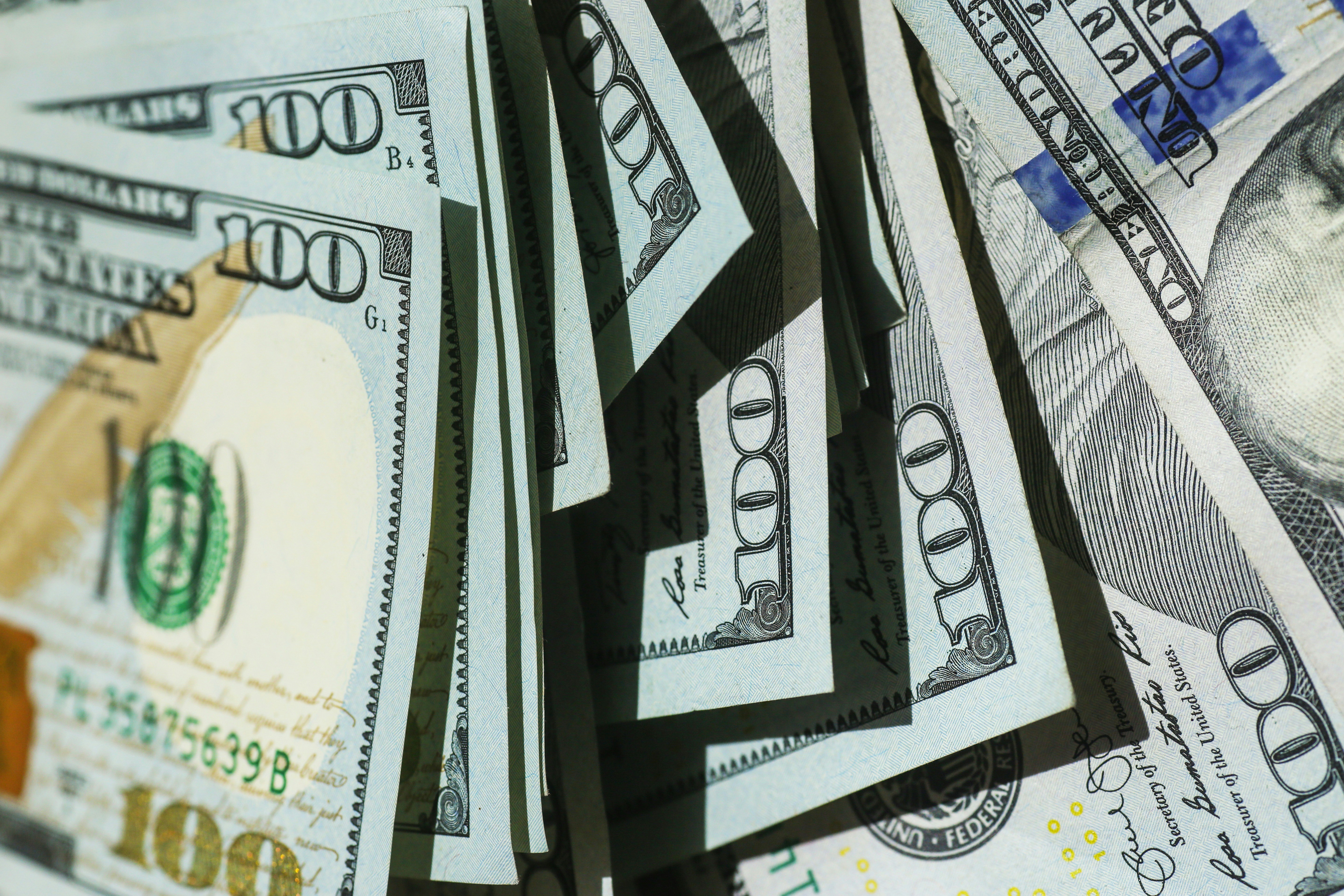 lots of 100 dollar bills to symbolize cash flow management.