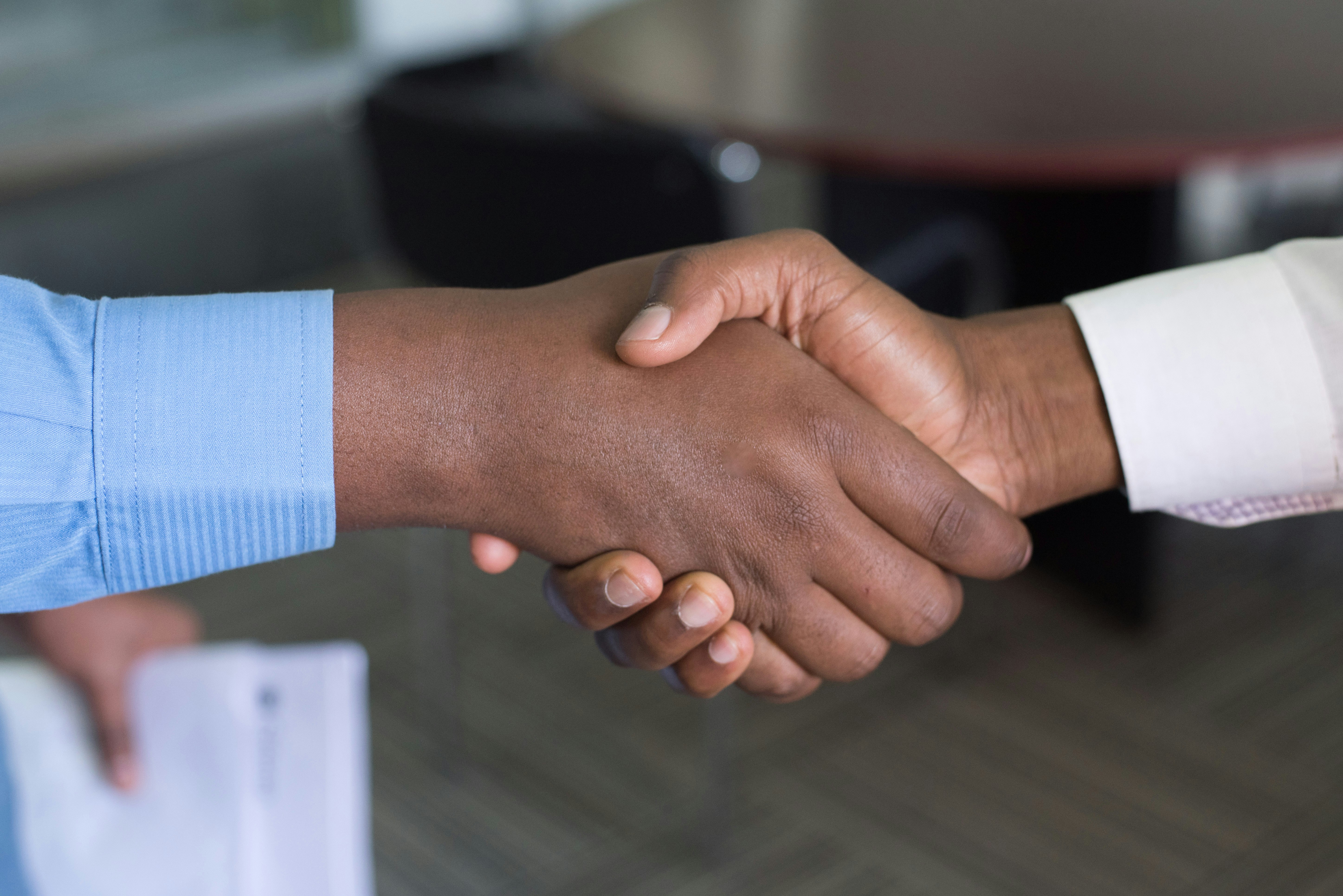 People shake hands to represent subrecipient and subrecipient monitoring